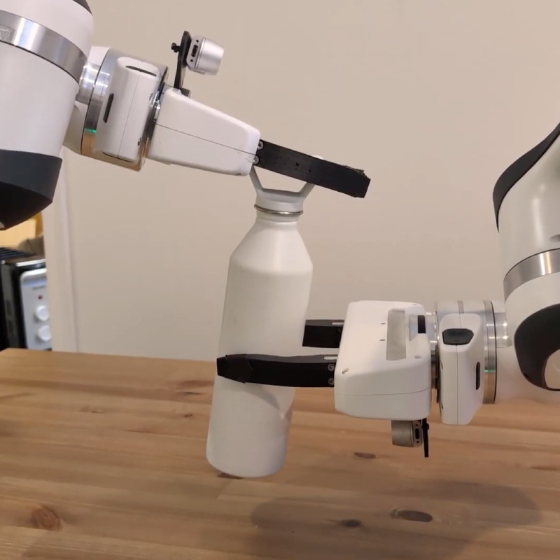 Image of a bimanual robot opening a water bottle.
